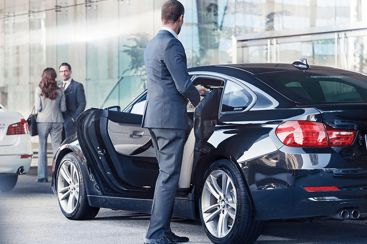 Uniformed chauffeur delivering Homer Glen Limo Service to an executive client